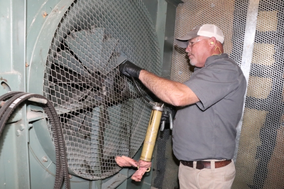 hays employee inspecting fan