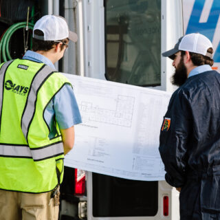 hays employees inspecting blueprints
