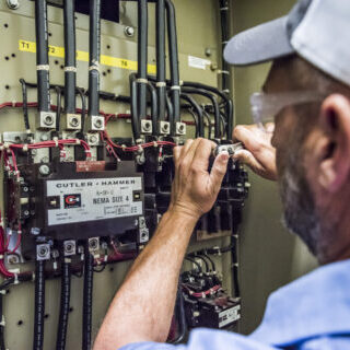 hays employee inspecting wiring
